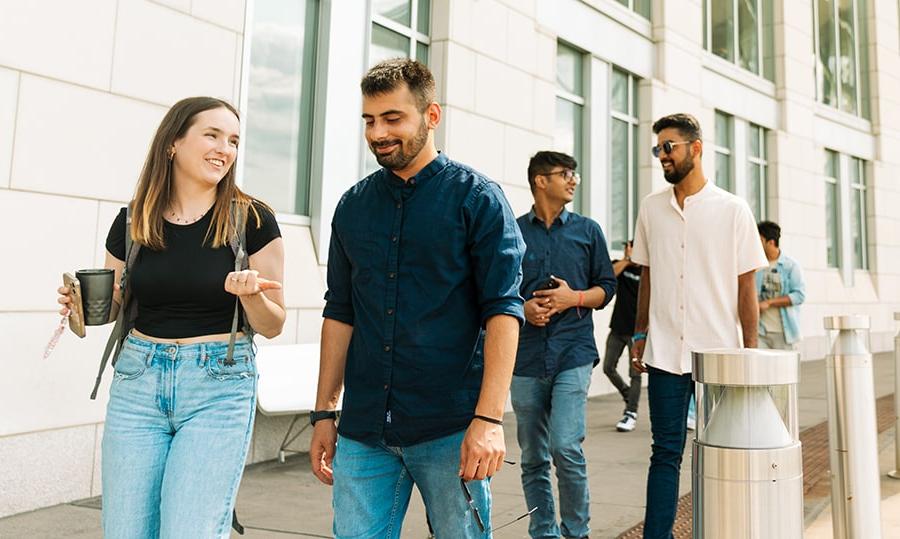 graduate students walking outside Campus Center